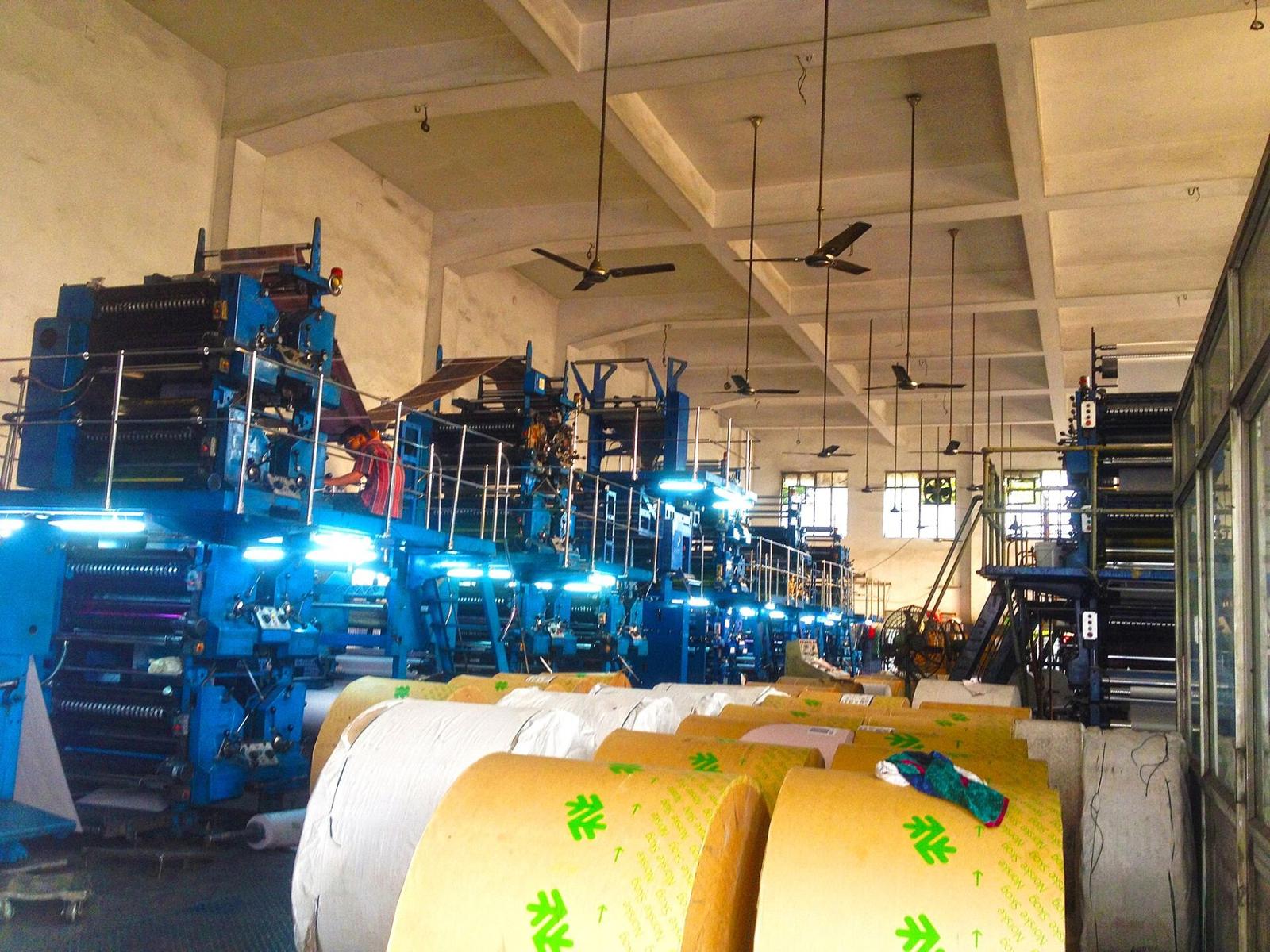 Offset presses and paper reels on a print-shop floor in India