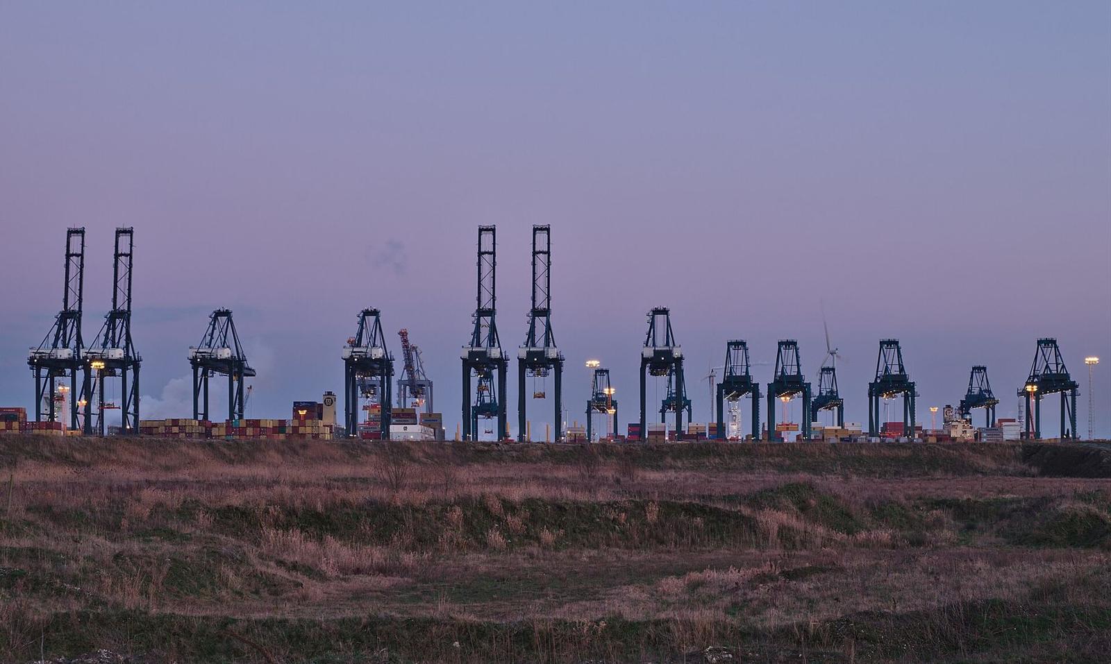Container cranes at a port terminal at dusk