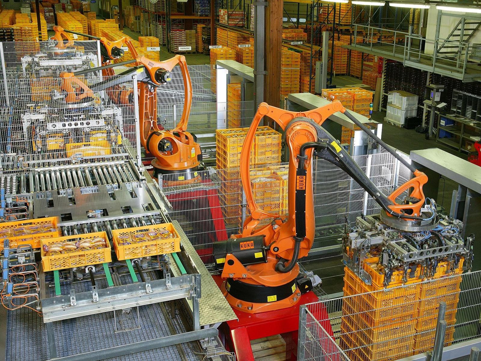 Industrial robots palletising on a factory floor
